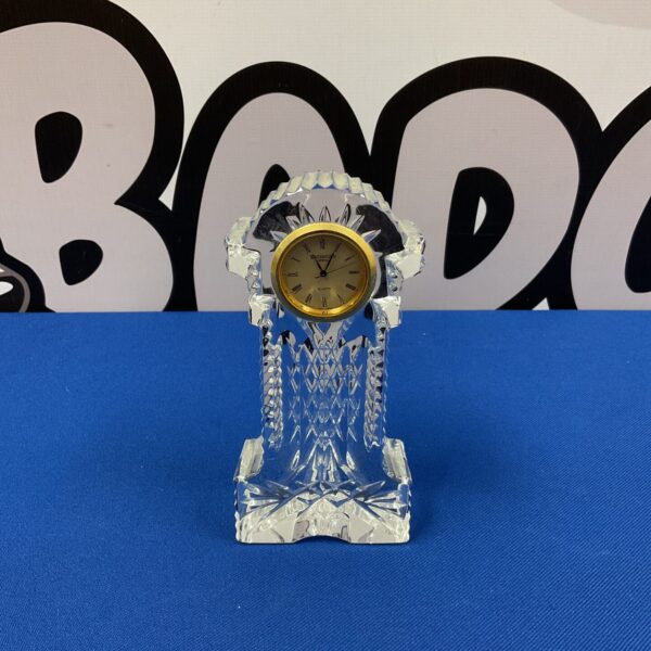 Elegant Waterford crystal clock with clear sculpted design.