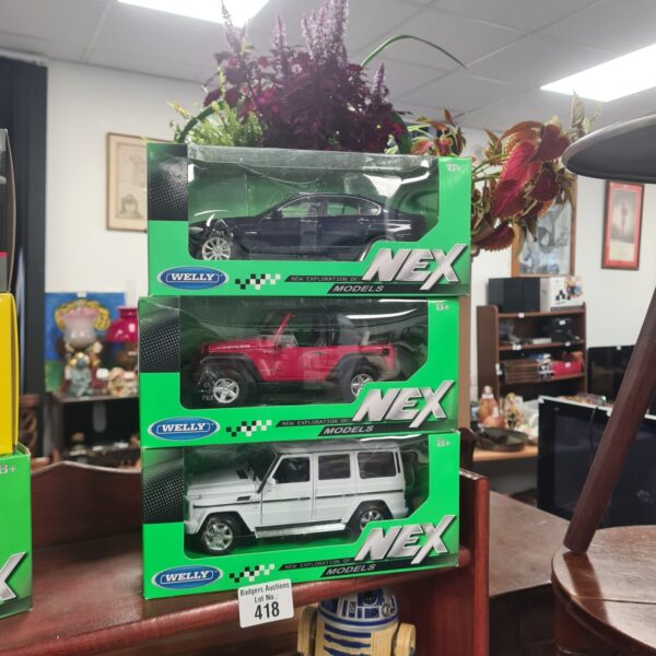 Boxed Welly NEX diecast model cars for collectors.