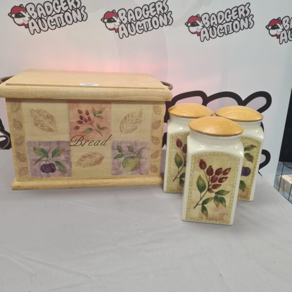 Floral decorated wooden bread bin set with ceramic jars.
