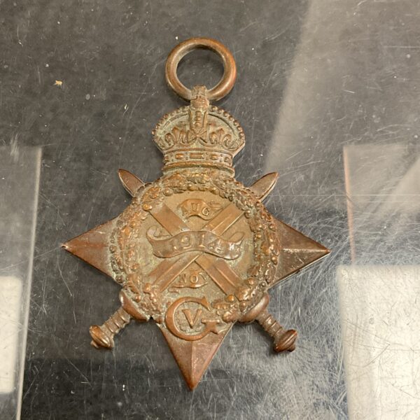Front view of a 1914 Mons Star medal with legible naming.