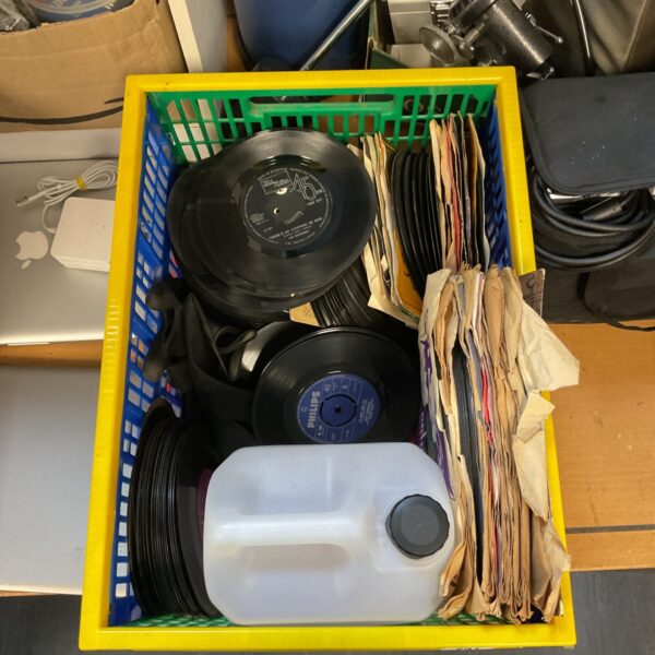 Vintage 45 records lot with cleaning kit for vinyl collectors.