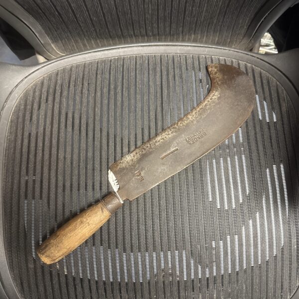 Antique Brades billhook with curved blade and wooden handle.