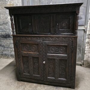 Intricate carvings on antique carved oak wardrobe.