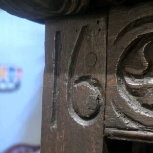 Intricate antique carved wood panel with floral relief carving.