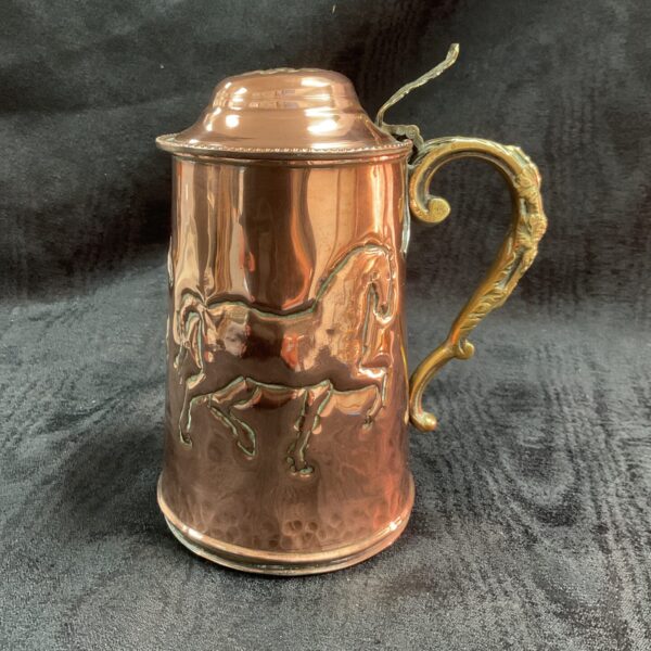 Antique copper tankard with embossed horse designs, Victorian era.