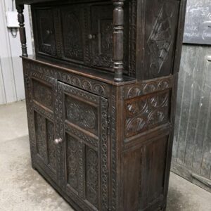 Detailed view of antique oak cupboard carving.