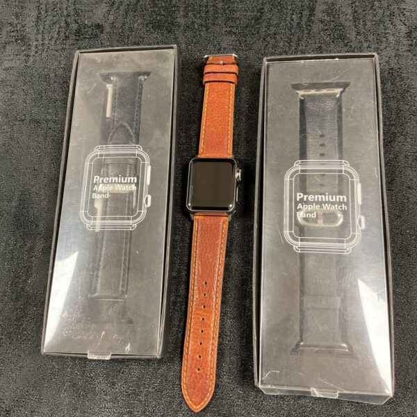 Leather Apple Watch strap with buckle closure.