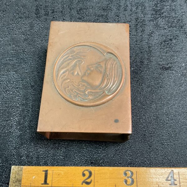 Antique Art Nouveau copper matchbox holder with repoussé design.