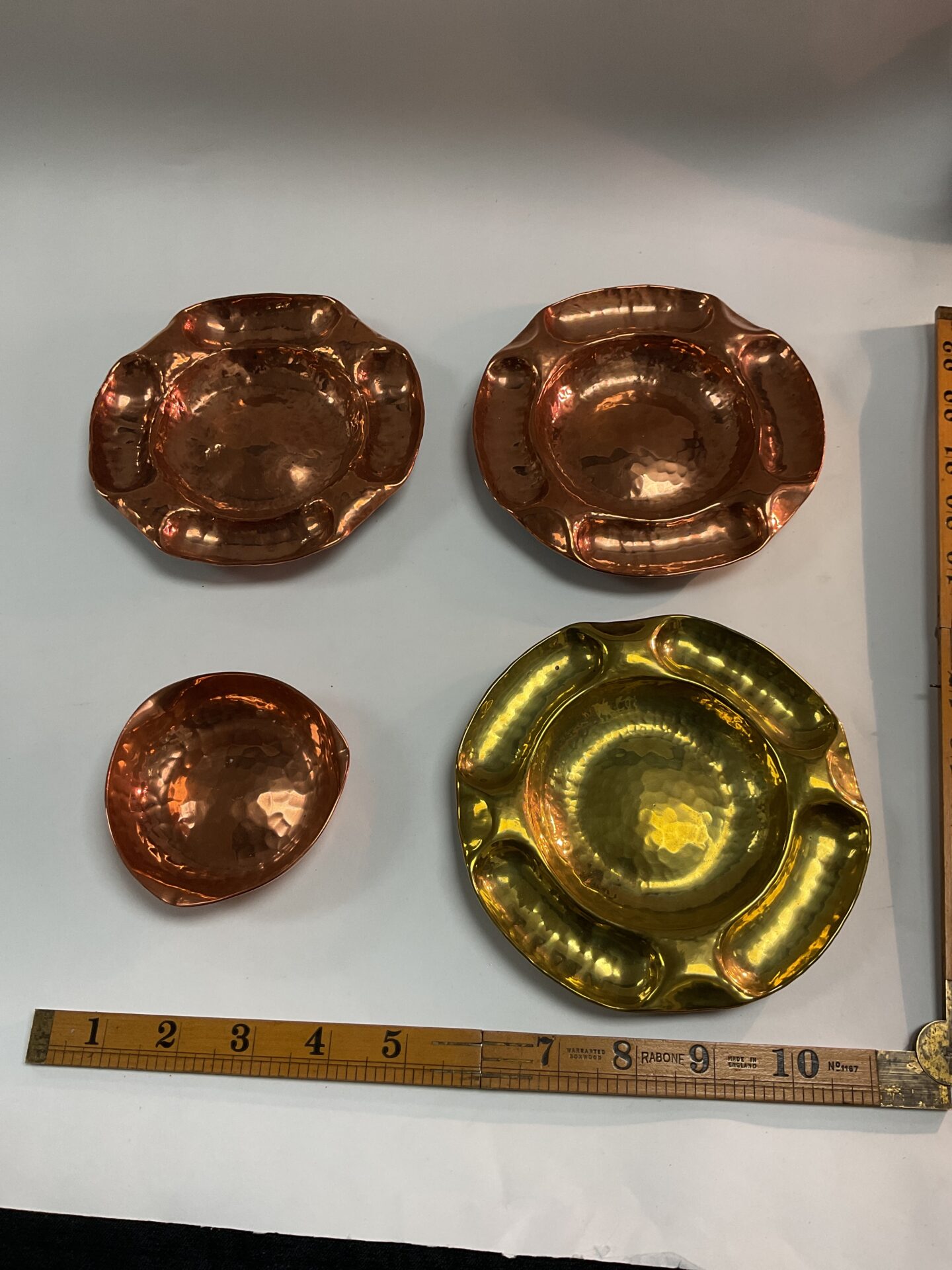 1030 Three Copper and one brass Arts and crafts hand hammered Dishes possibly by Norman and Ernest Spittale