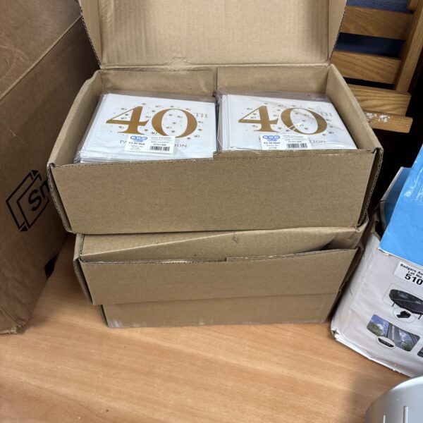 Three boxes of 40th birthday invitation cards for celebrations.