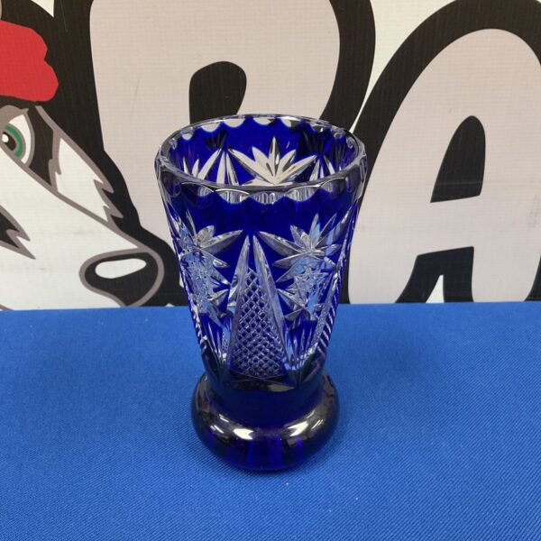 Vibrant cobalt blue Bohemian cut glass vase with intricate patterns.