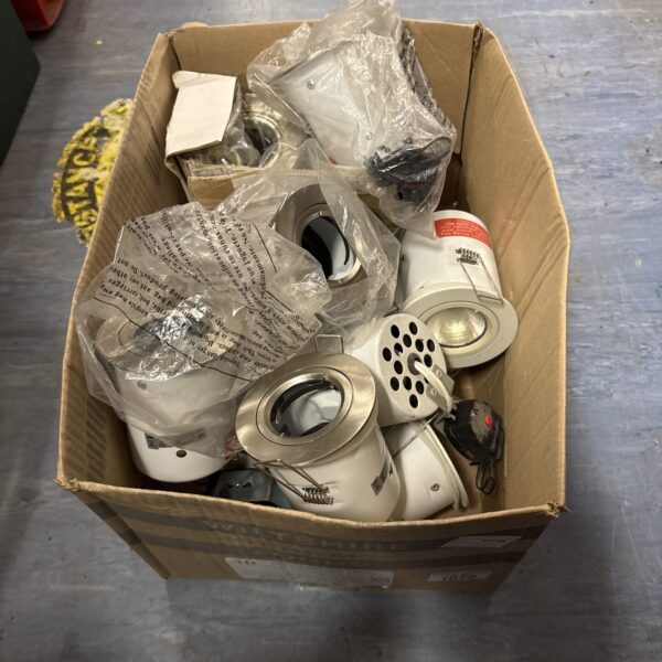 Box of assorted downlights for recessed ceiling lighting.