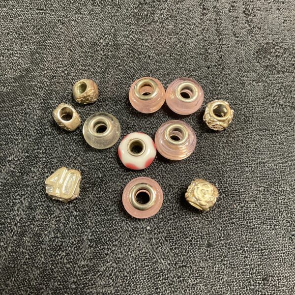 Close-up of vintage glass and metal bracelet beads.