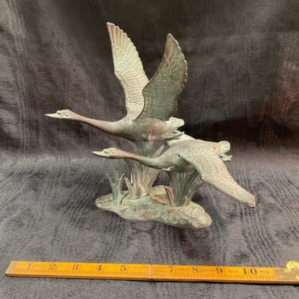 Vintage brass sculpture of Canada geese in flight.