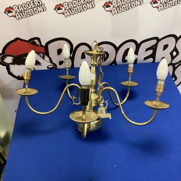 Vintage brass chandelier with multiple arms for hall or dining lighting.