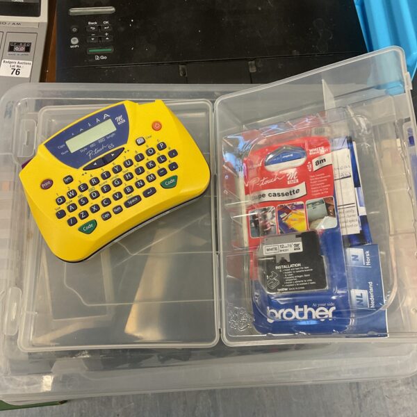 Vintage Brother P-Touch 65 label maker with tape cassette.