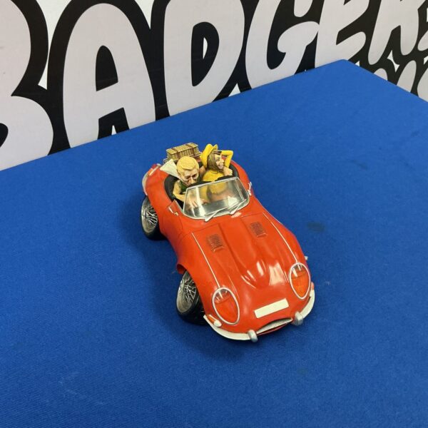 Red Car Courure ornament for festive holiday decoration.