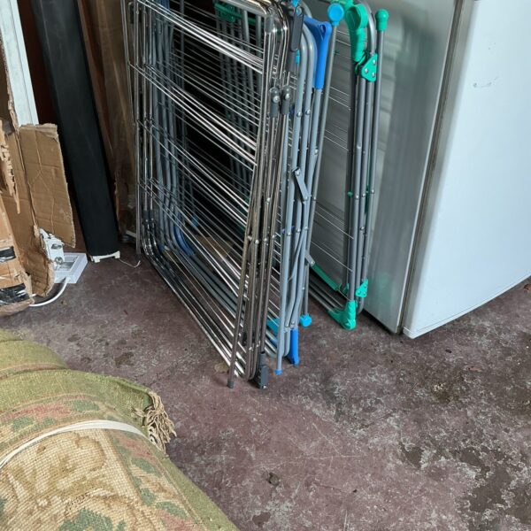Set of five metal clothes horses for indoor laundry.