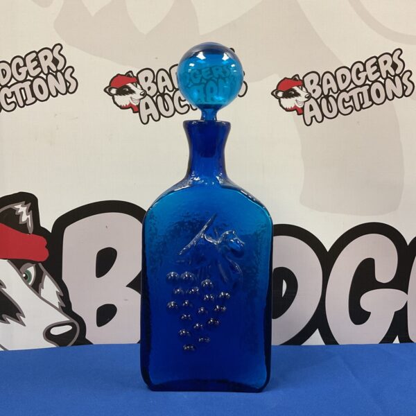 Antique cobalt blue glass bottle with raised grape design.