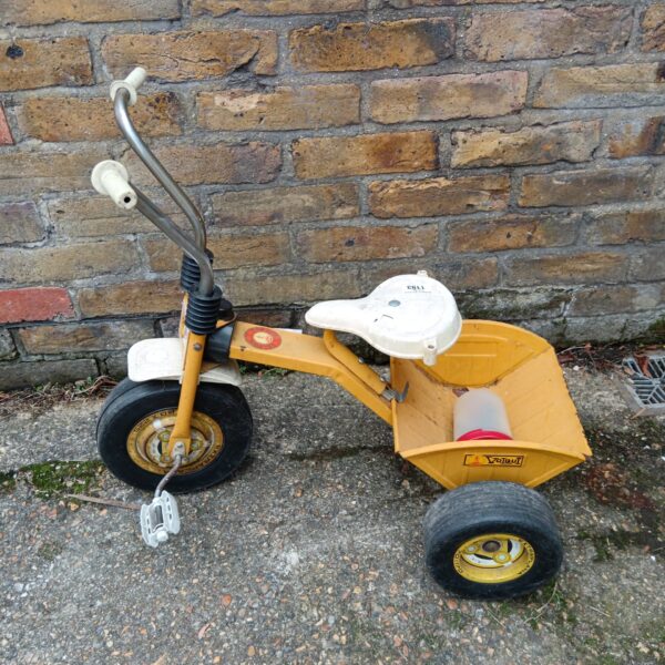 Yellow vintage Colmor Pastor trike, a classic child's toy.