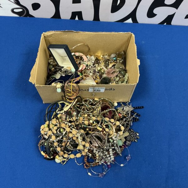 A close-up view of a costume jewellery lot with necklaces and beads.