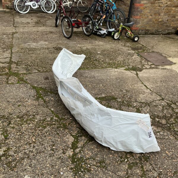 New Ford Focus bumper in storage with bicycles.