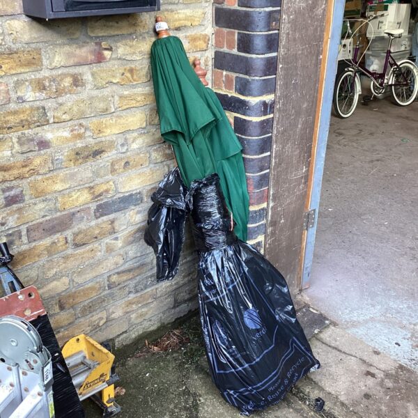 Two used garden parasols with dark green and black frames.