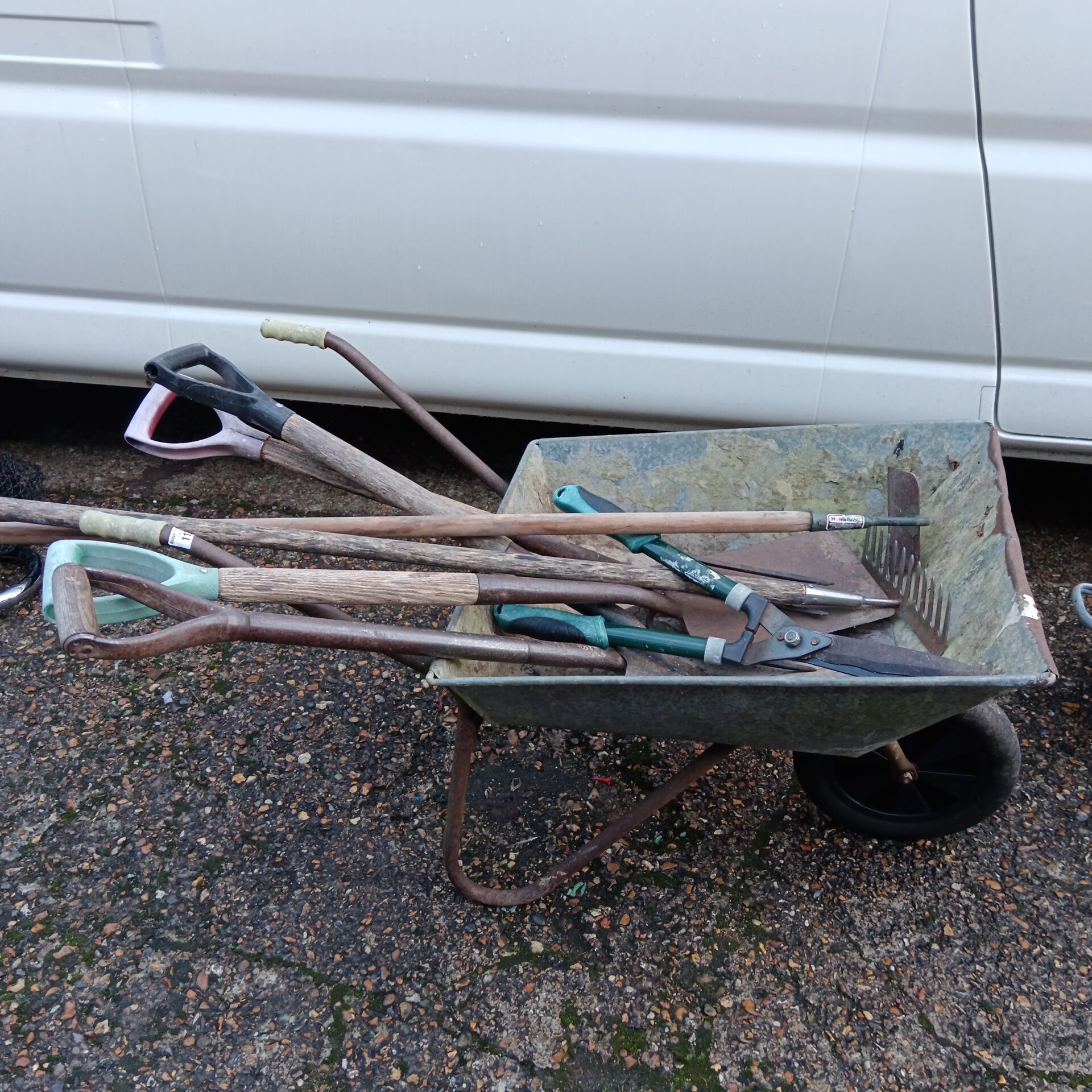 1122 Galvanised wheelbarrow & selection of garden tools