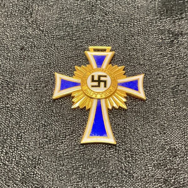 Front view of a gilt German Mothers Cross with blue enamel.