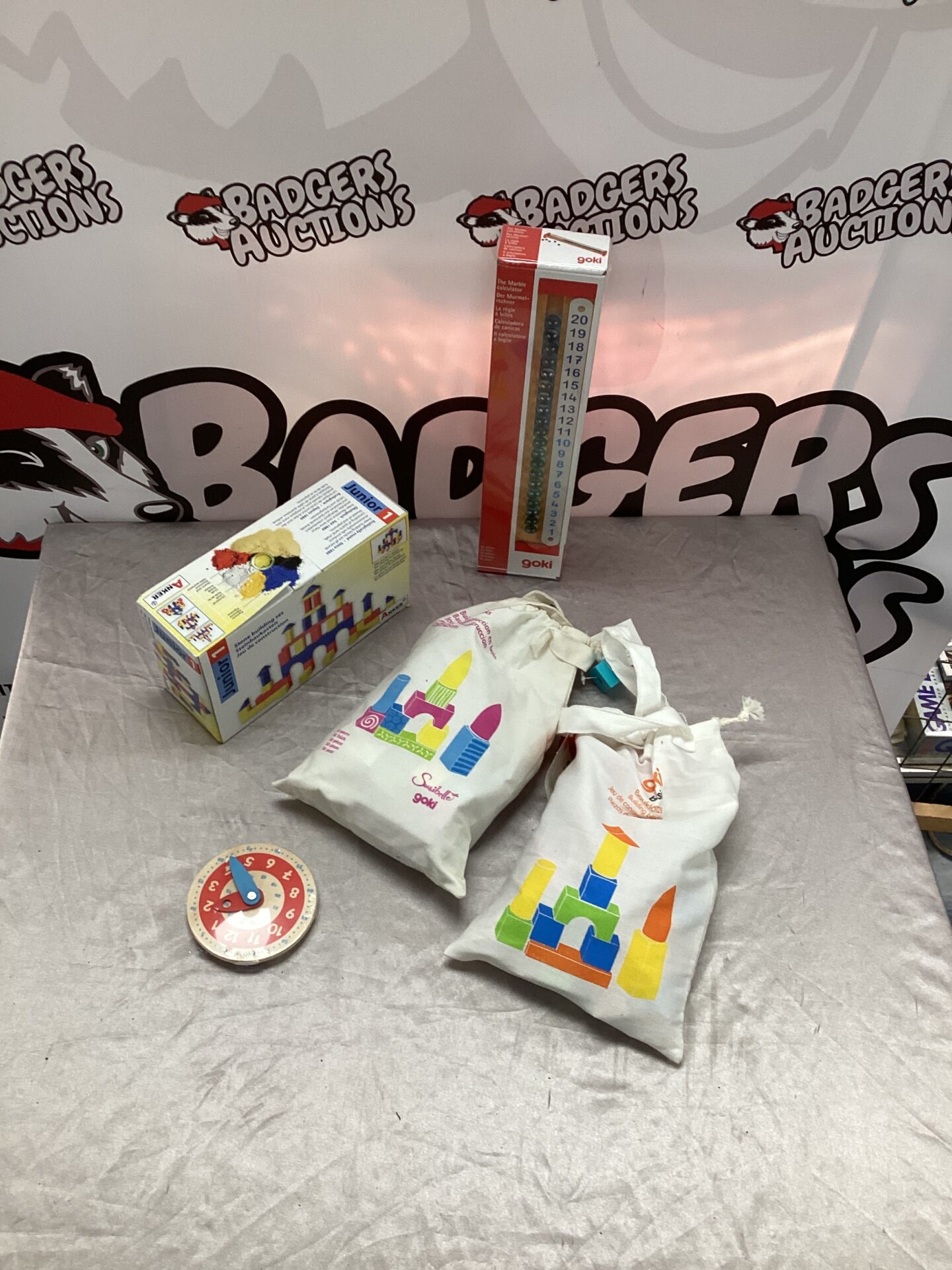 396 Two bags of goki childs building blocks, goki marble calculator & junior set of stone building blocks