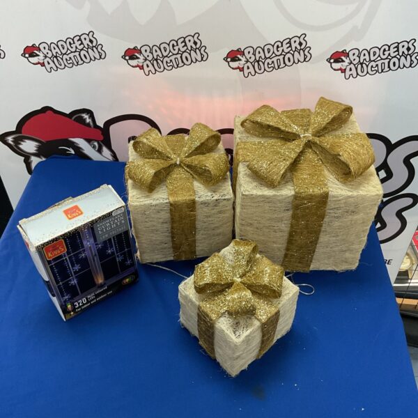 Illuminated gift box set with snowflake curtain lights for festive winter decor.