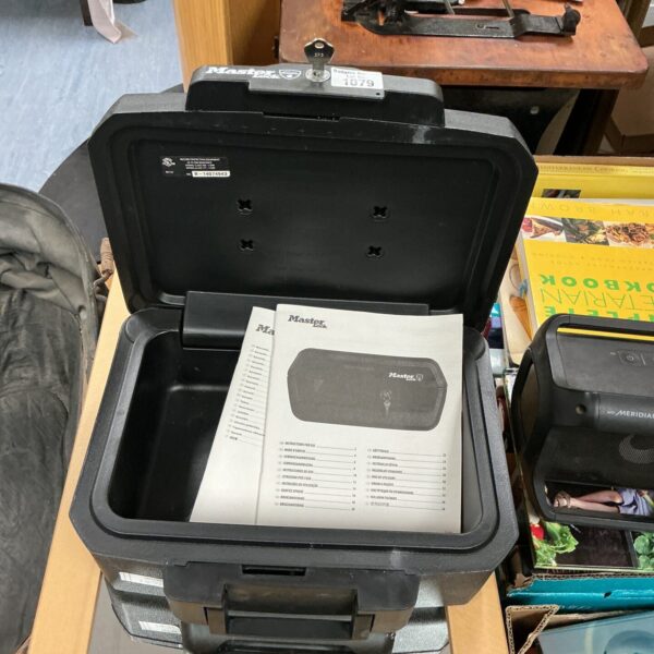Open Master Lock secure box with key and interior visible.