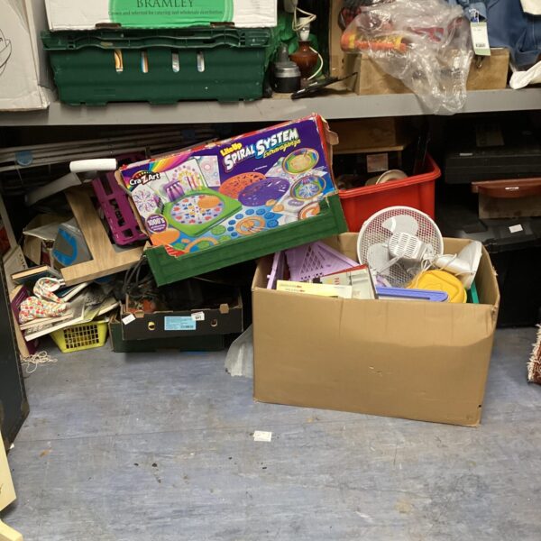 Mixed lot of uncollected items on a storage shelf.