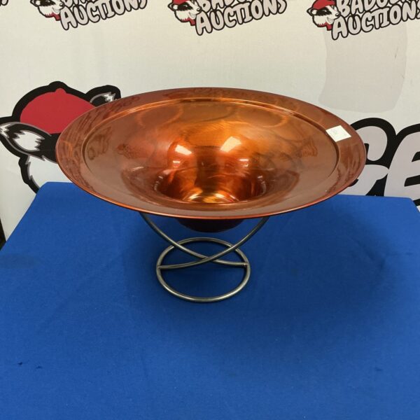 Vibrant orange spun metal bowl with stand, mid century modern style.