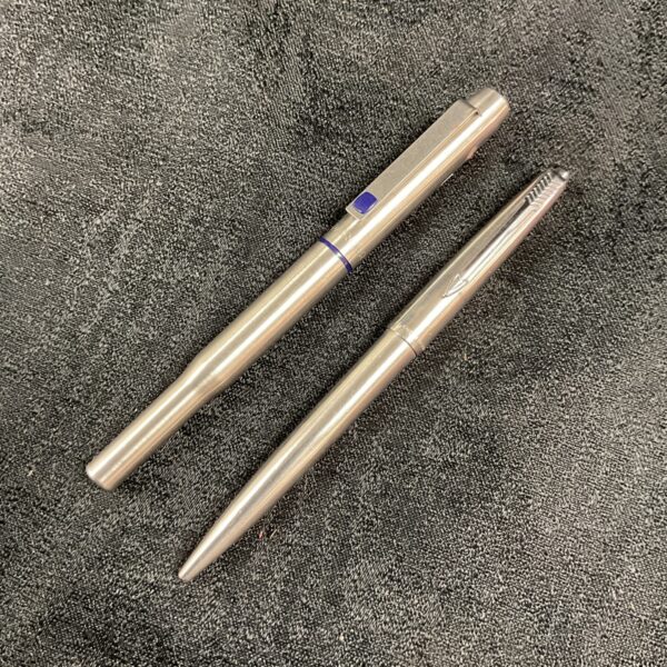 Silver-toned Parker pen pair, vintage collectible writing instruments.