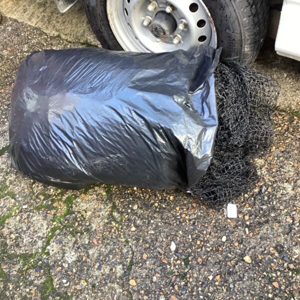 Black roll of pond netting for garden pond protection.