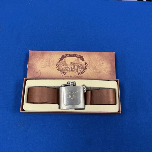 Vintage Portland drinks flask with a leather belt.