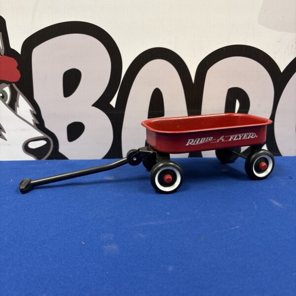 Red Radio Flyer miniature wagon, vintage toy collectible.