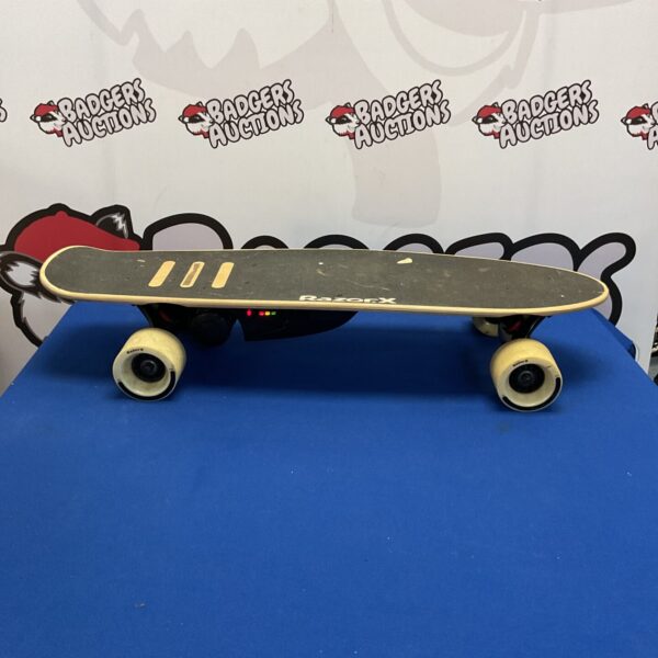 Side view of a used Razor x electric skateboard.
