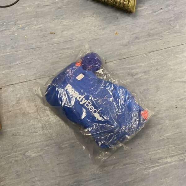 Blue Readybed air bed with built-in pump, ready for travel.
