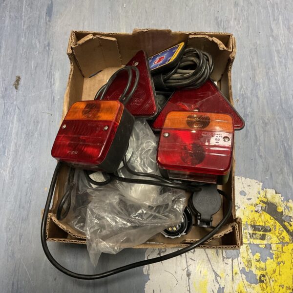 Red plastic trailer lamps for vehicle towing.