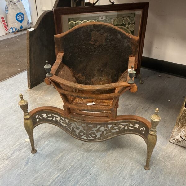 Ornate Victorian fireplace insert with brass detailing.