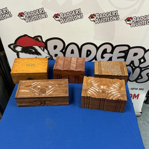 Lot of five vintage carved wooden boxes with intricate designs.