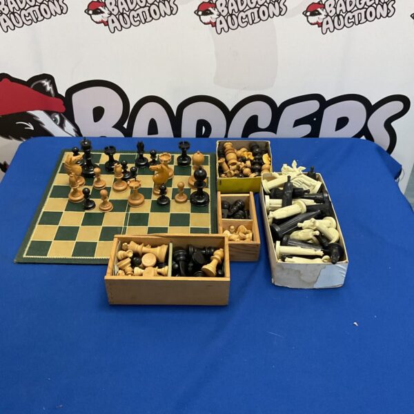 Vintage chess set collection with multiple designs and pieces.