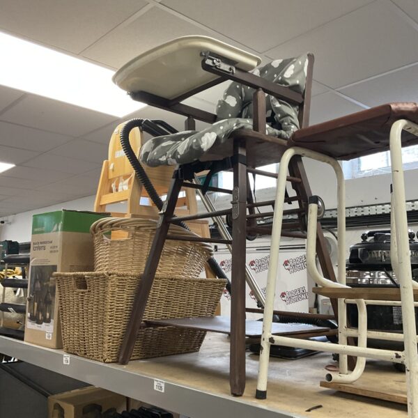 Vintage child's high chair with woven wicker seat.