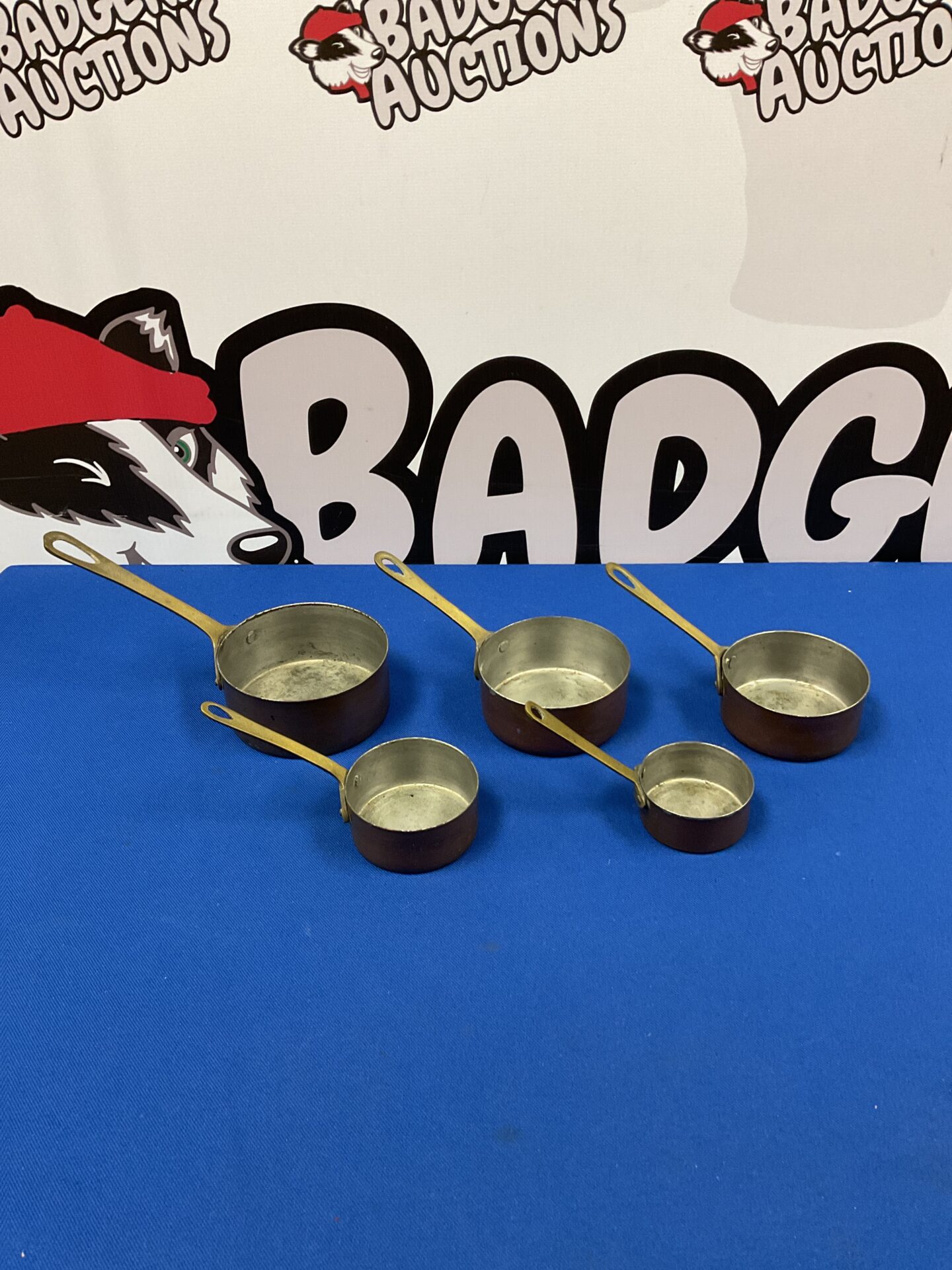 053 Set of five vintage graduated copper pans with brass handles