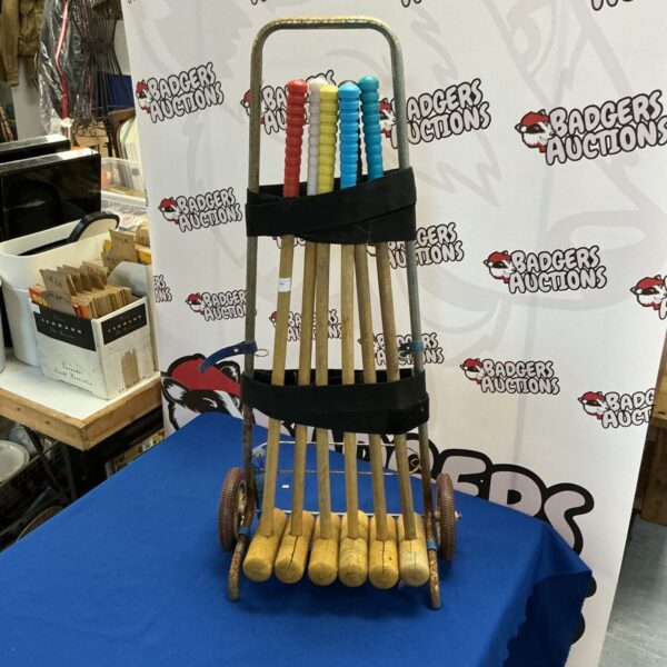 Vintage croquet set with colourful mallets and stand.