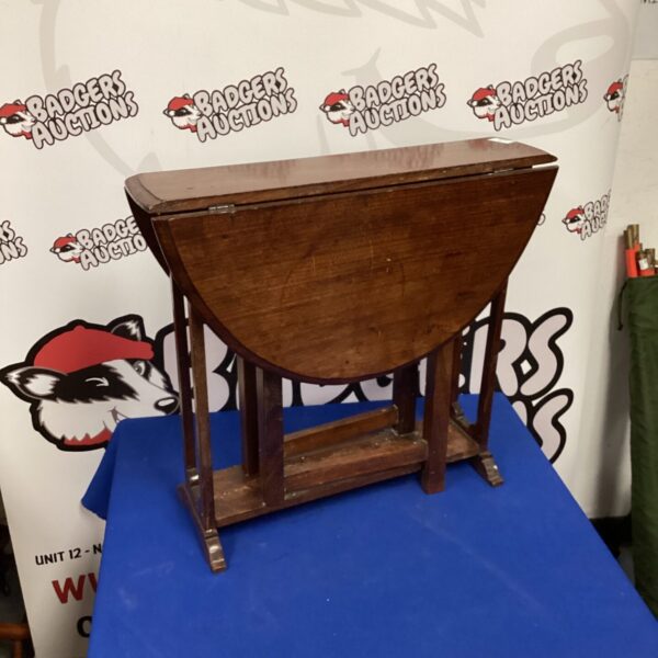 Vintage drop leaf table with wooden tabletop and legs.