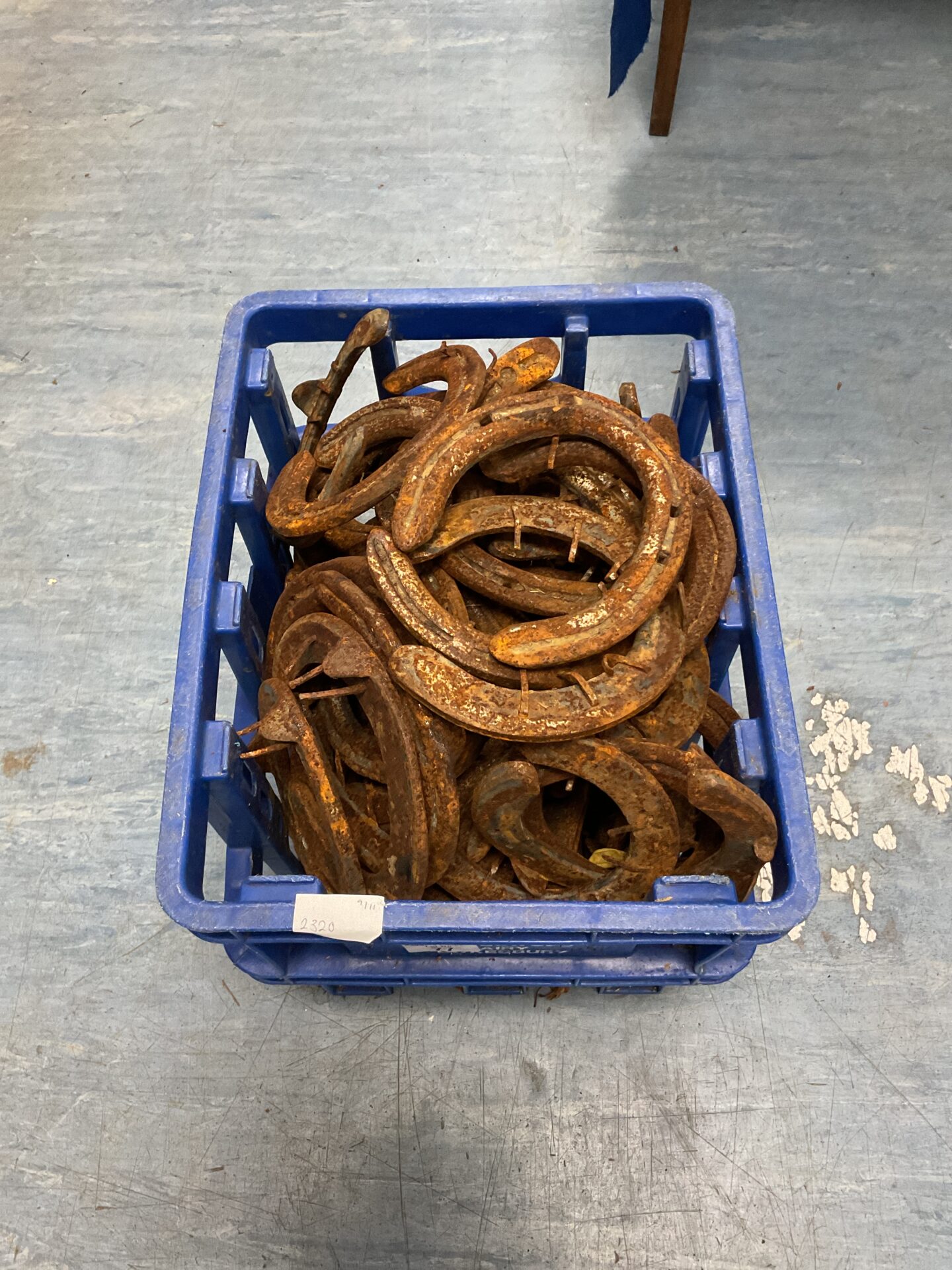 077 Crate full of vintage horse shoes