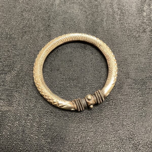 Vintage Indian silver bangle with textured surface.